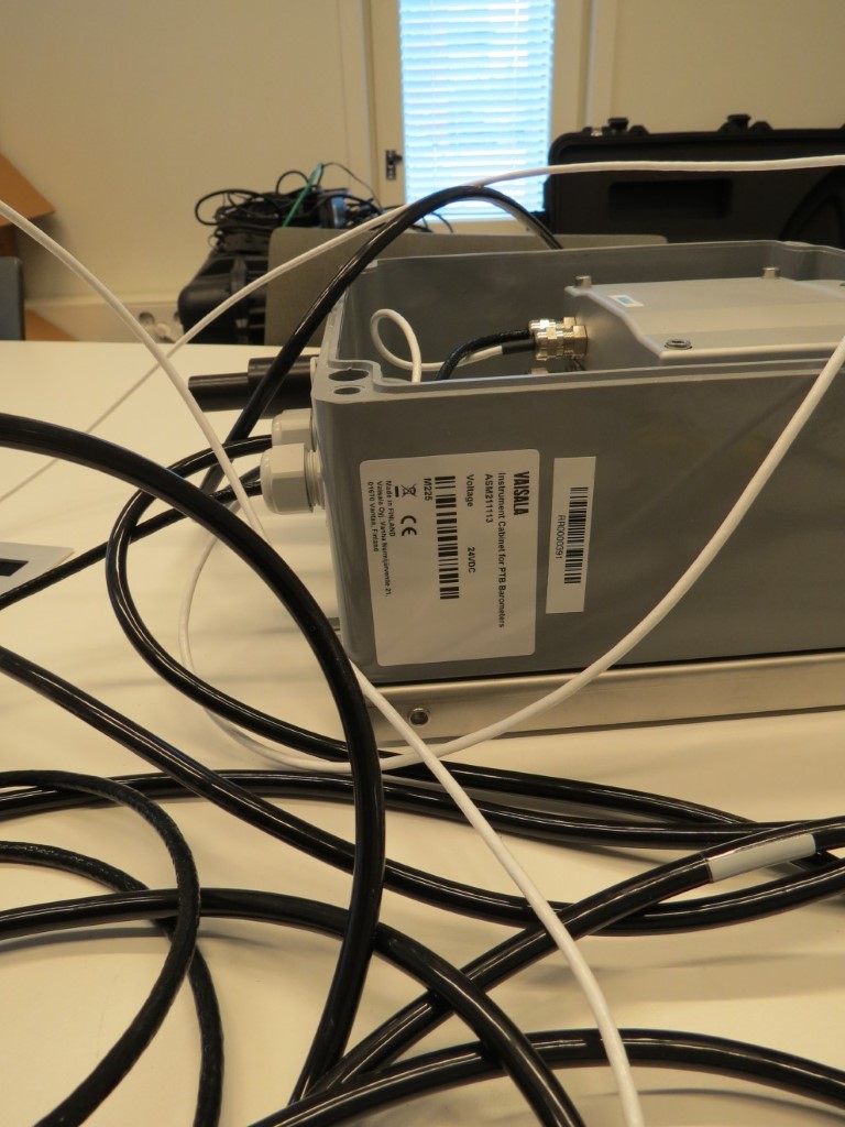 Vaisala industrial meteorological and visibility sensor suite integrated for atmospheric attenuation testing.